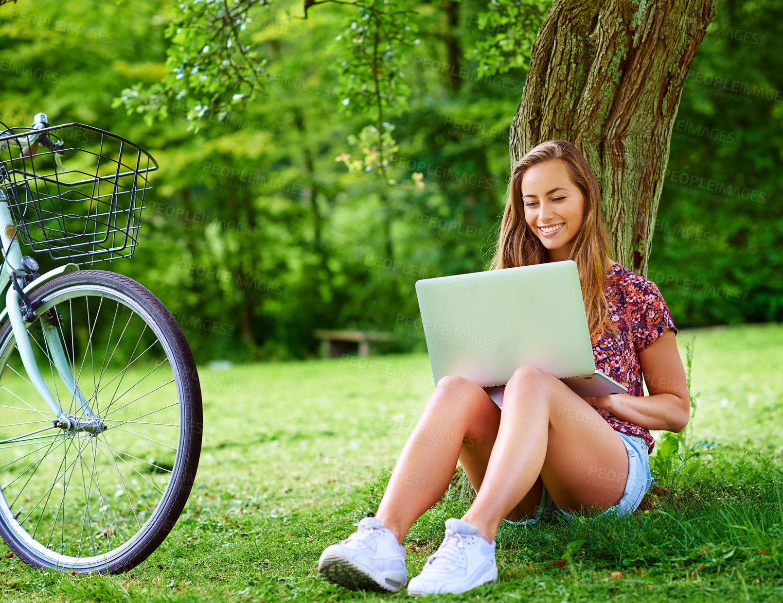 Buy stock photo Laptop, bicycle and woman on grass in park with smile, research and online education with internet. Studying, relax and happy girl with bike, computer and website for elearning on field in nature