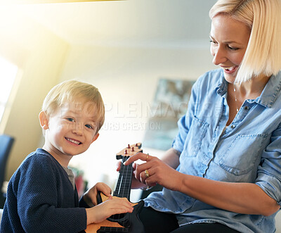 Buy stock photo Music, mother and portrait of kid with guitar and smile playing song for child development in home. Learning, happy parent or creative boy in practice with acoustic instrument, mom or artistic talent