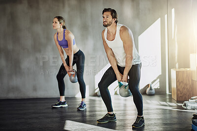 Buy stock photo Workout, man and woman in gym with kettlebell, fitness and power at training challenge together. Couple, sports club and personal trainer with weights, muscle development and healthy body exercise