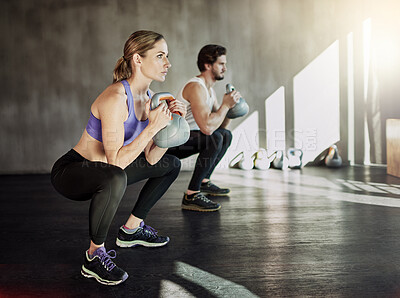 Buy stock photo Muscle, squat and couple in gym with kettlebell, power training and workout challenge together at sports club. Man, woman or personal trainer with fitness development, healthy body and exercise.