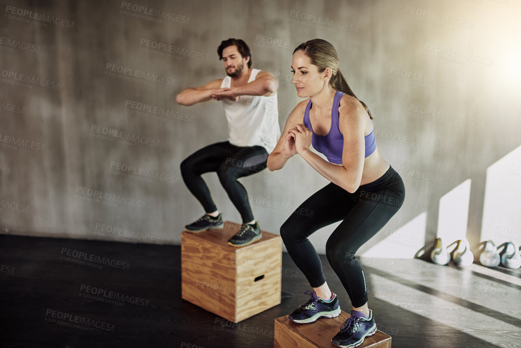 Buy stock photo Jump, training and couple in gym with box, power and fitness at workout challenge together. Man, woman and personal trainer with balance, muscle development and healthy body exercise at sports club