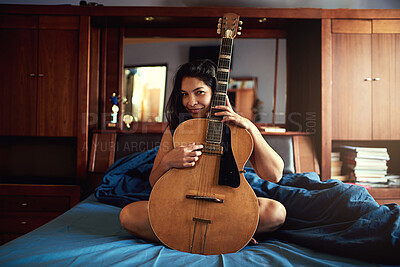 Buy stock photo Guitar, playing and woman artist on bed learning song for performance, recital or concert. Musical, guitarist and portrait of female musician with big string instrument for hobby in bedroom at home.