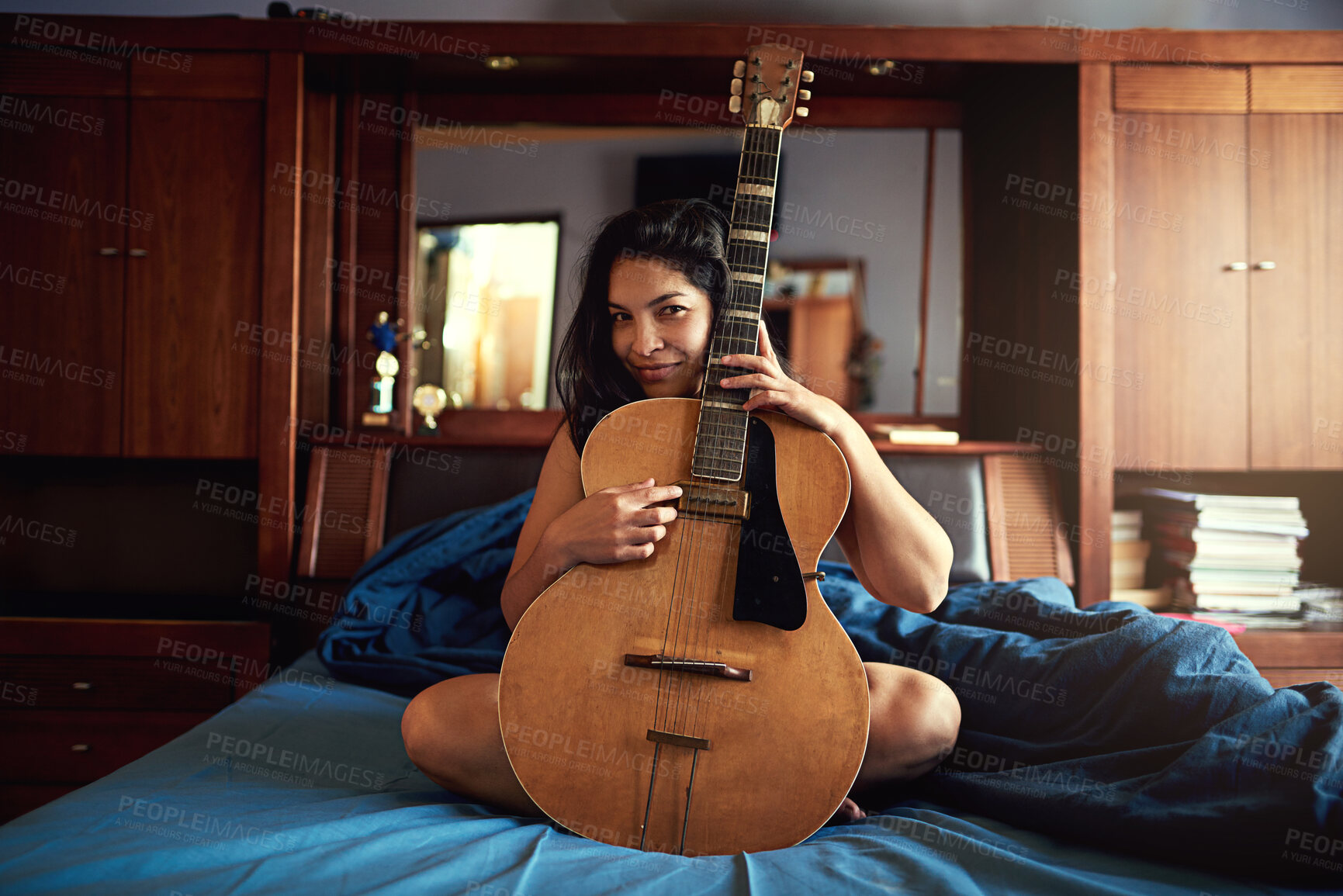 Buy stock photo Guitar, playing and woman artist on bed learning song for performance, recital or concert. Musical, guitarist and portrait of female musician with big string instrument for hobby in bedroom at home.