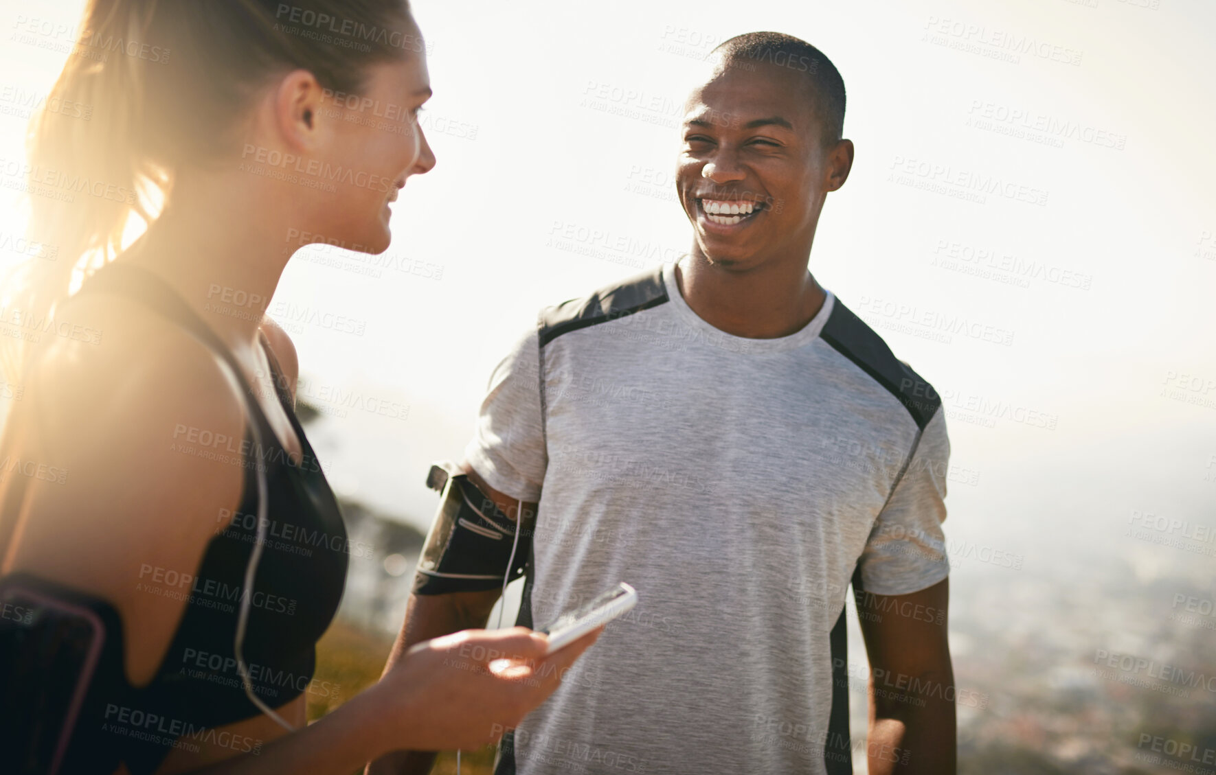 Buy stock photo Shot of a fit young couple working out together outdoors