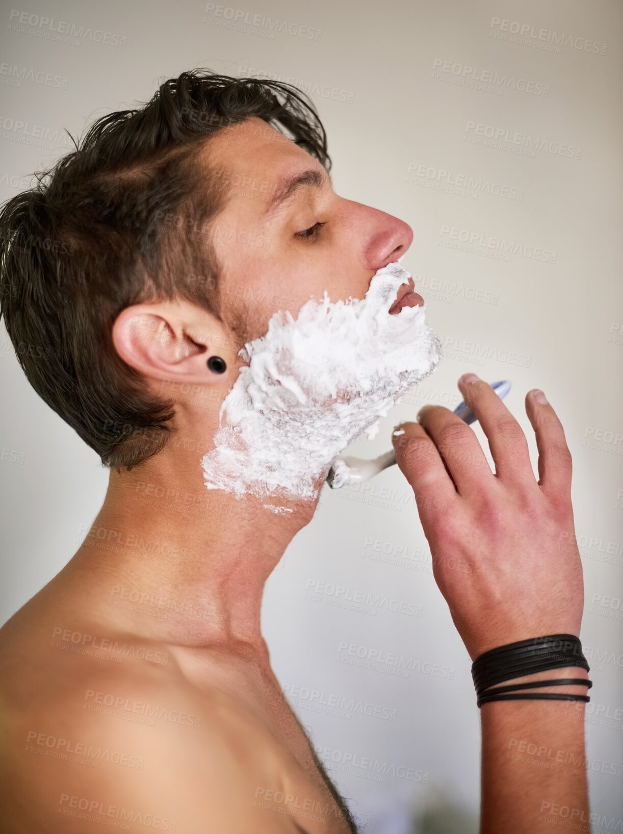 Buy stock photo Man, shave and cream with razor blade for grooming, skincare or hair removal in bathroom at home. Profile of male person with creme, cosmetics or foam on beard for morning routine or facial at house