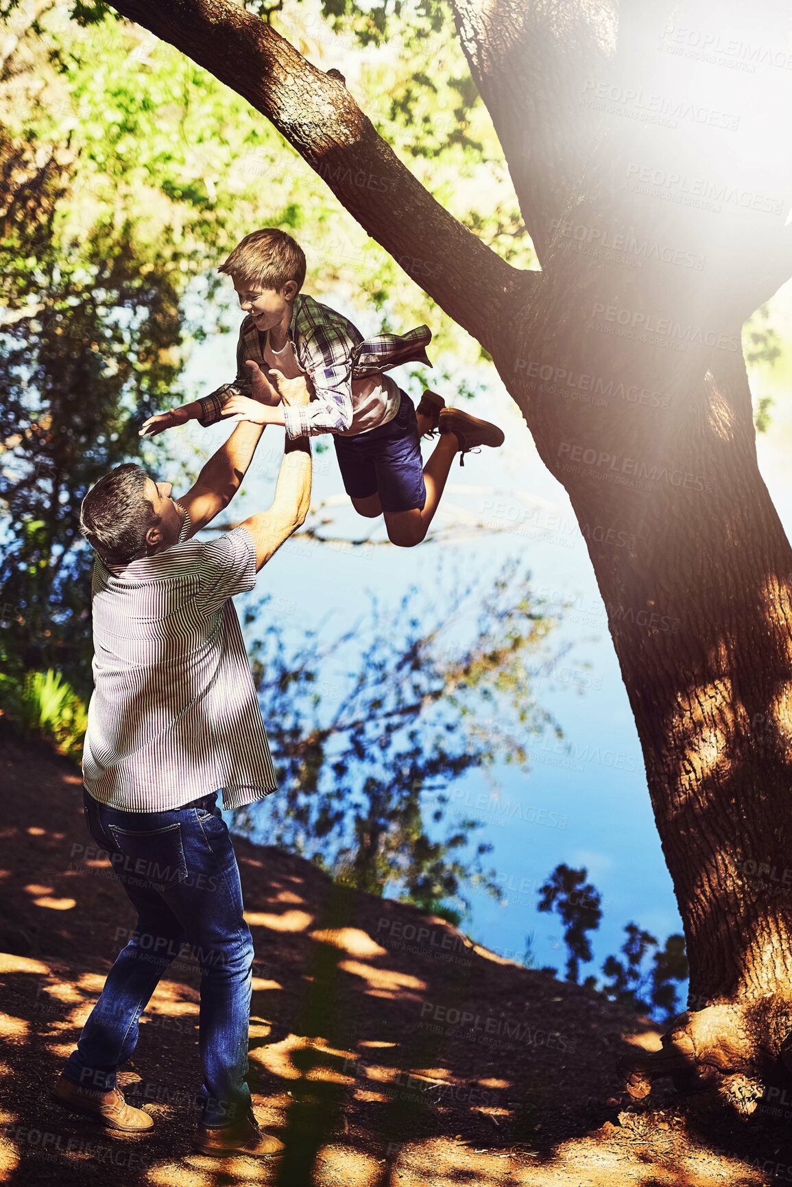 Buy stock photo Father, child and throw in air in nature for bonding, love or laughing together on vacation in woods. Dad, boy and kid with funny game, playing or happy family hiking in forest by lake in countryside