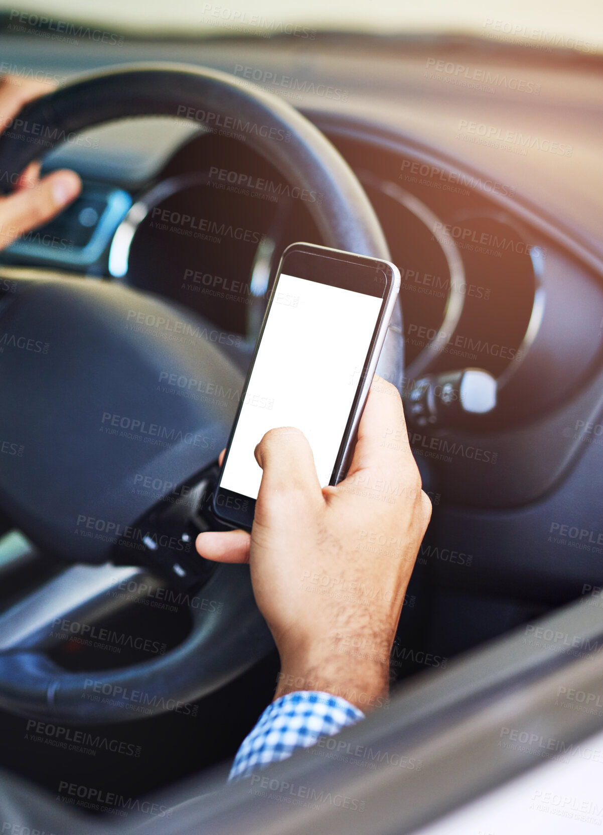 Buy stock photo Cropped shot of a man using his phone while driving