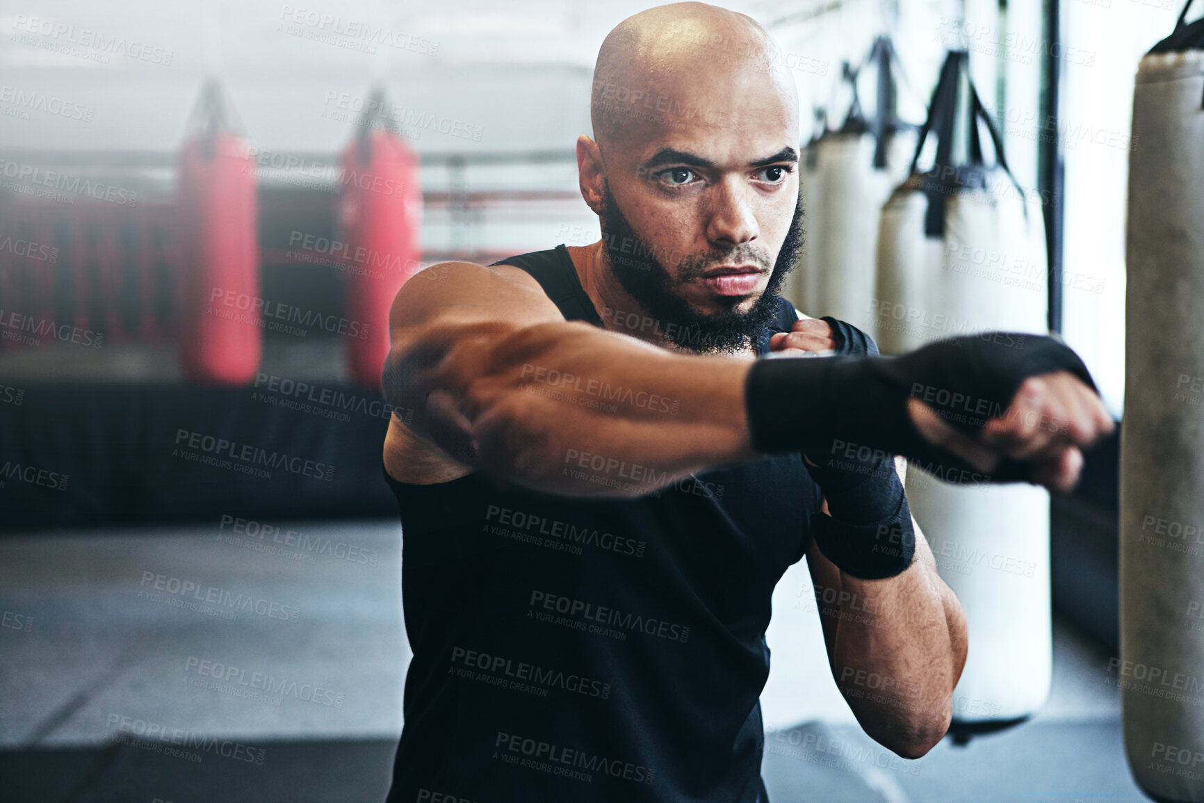 Buy stock photo Fitness, punching and man in gym for boxing challenge, exercise or competition training. Power, muscle and champion boxer at workout with confidence, fight and energy in MMA sports club with gloves.