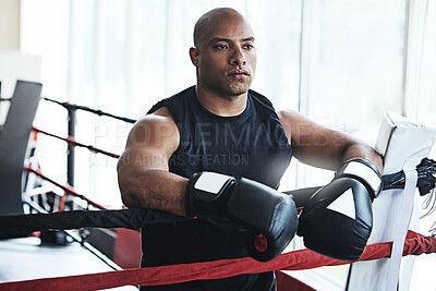 Buy stock photo Serious, boxer and man on rope in ring for challenge, exercise and training competition for body health. Workout, fight and sport athlete resting on break for thinking, fitness or wellness at gym