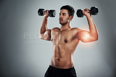 Buy stock photo Person, dumbbell and muscle injury in studio, growth and ache for weightlifting, power or health by grey background. Man, bodybuilder and red glow for pain, overlay and accident for bicep in workout