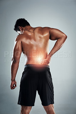 Buy stock photo Studio, fitness and man with lower back pain, physio and cramp at gym workout for bodybuilder training. Exercise, overlay and male athlete with muscle injury, red glow and ache on grey background