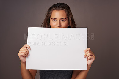 Buy stock photo Woman, poster and studio background in portrait for promotion, mockup space and advertising with tips. Female person, sign board and presentation with instructions, information and paper card