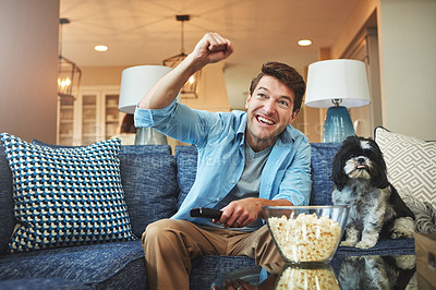 Buy stock photo Happy, man and dog with tv remote or popcorn in home on sofa for watching sports game, challenge and fun. Living room, couch and excited or smile with fist for celebration, win and entertainment