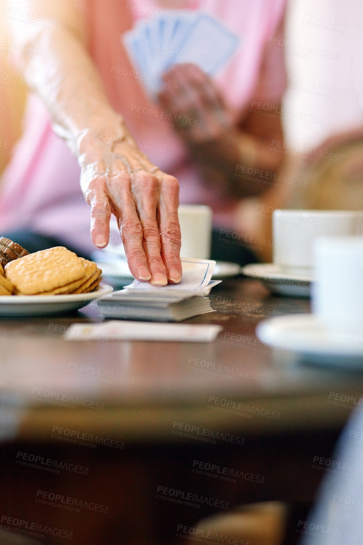 Buy stock photo Elderly woman, table and hand with cards in retirement home for activity, hobby and fun on weekend. Games, senior person and relax with snack in living room for problem solving, strategy and contest