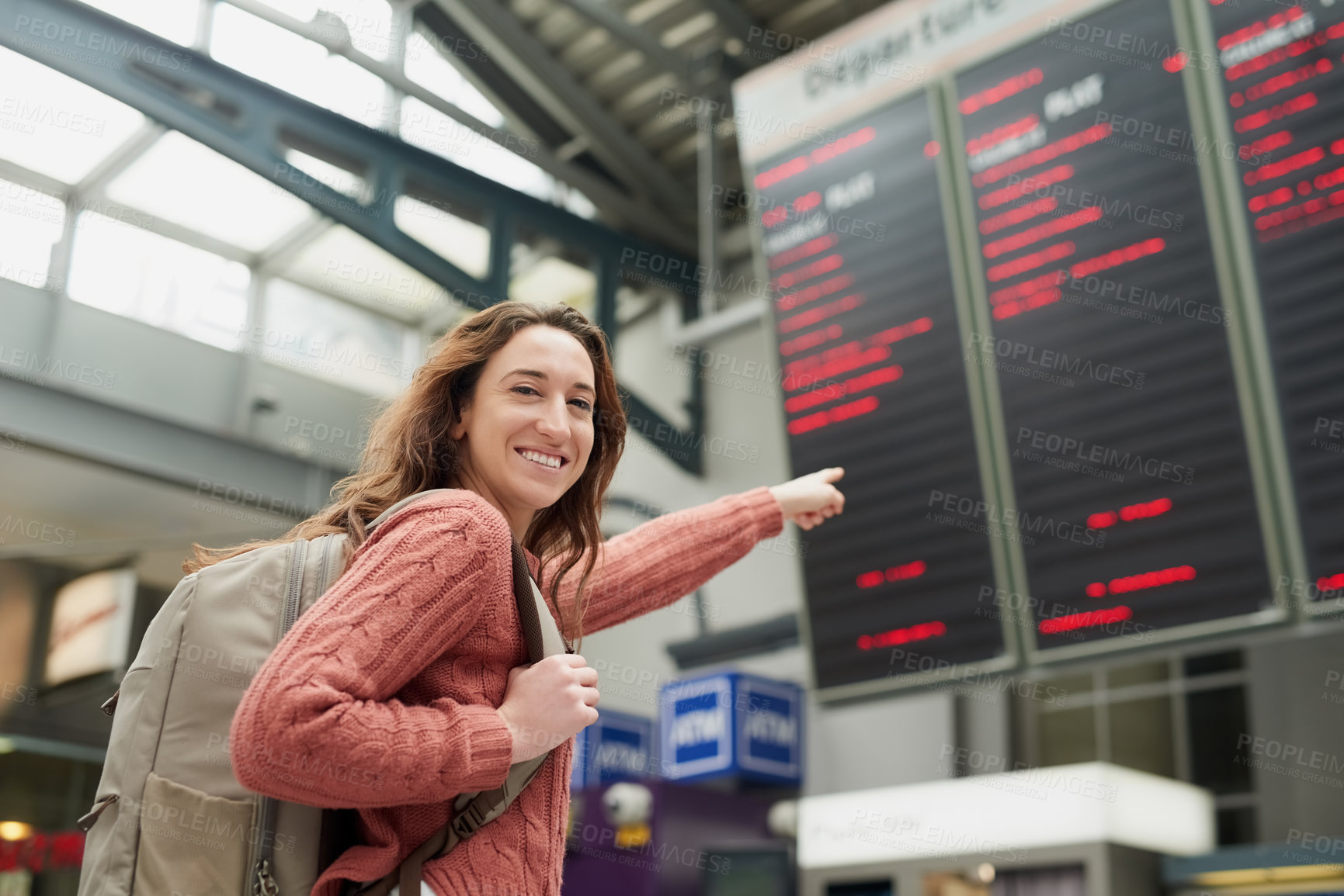 Buy stock photo Woman, airport and point at information on board for flight schedule with smile for immigration in portrait. Person, backpack and happy on international travel with digital timetable, screen and trip