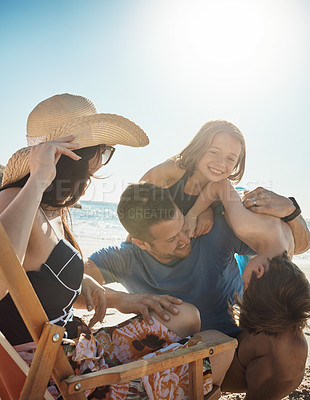 Buy stock photo Beach, family and parents playing with children on sand for  tropical holiday, vacation and adventure. Happy, summer and mom, dad and kids laughing by ocean for bonding, relaxing and fun outdoors