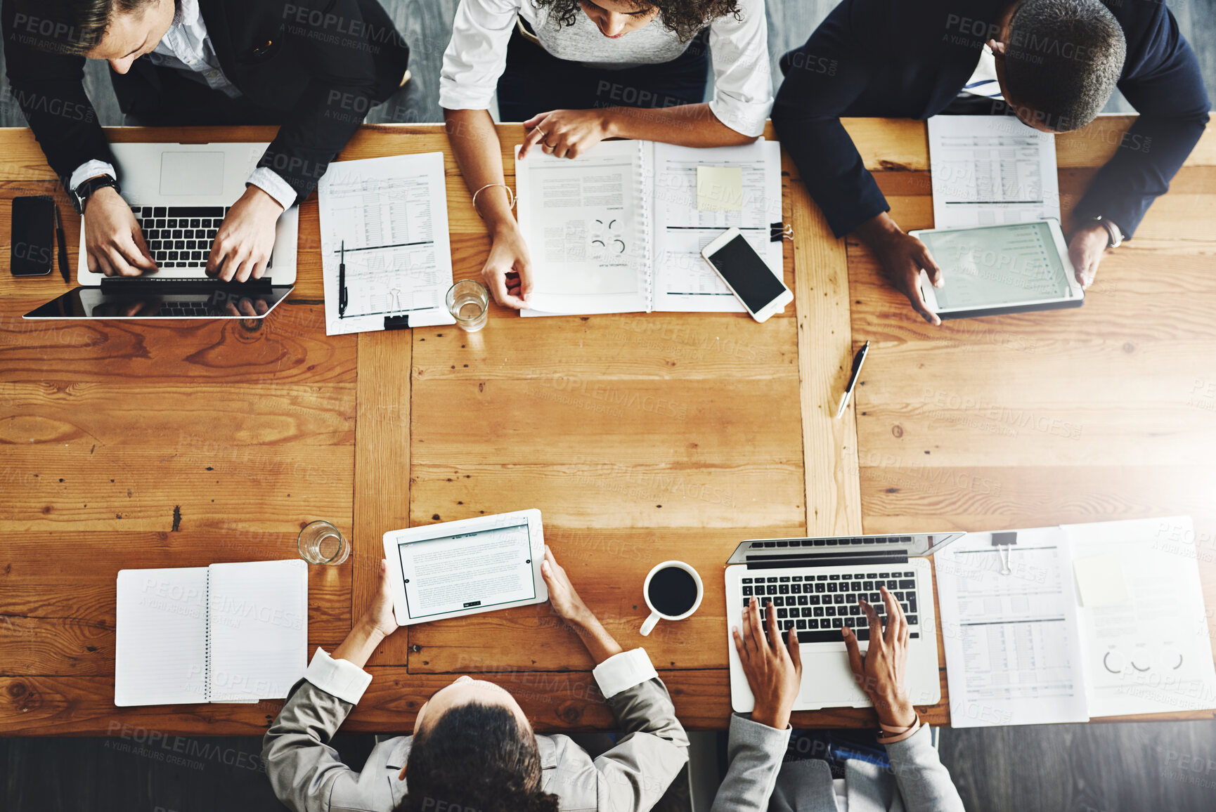 Buy stock photo High angle shot of a group of businesspeople having a meeting in an office