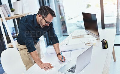 Buy stock photo Corporate, man architect with laptop or computer and sketch in office with notebook at his desk at work. Technology, entrepreneur and male person drawing in plan with pc on table in modern workspace
