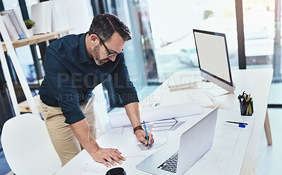 Buy stock photo Shot of a mature male architect using his laptop