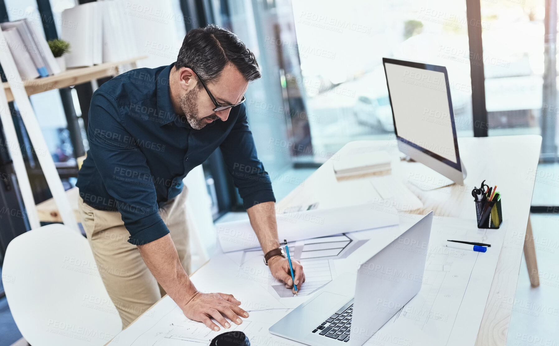 Buy stock photo Shot of a mature male architect using his laptop