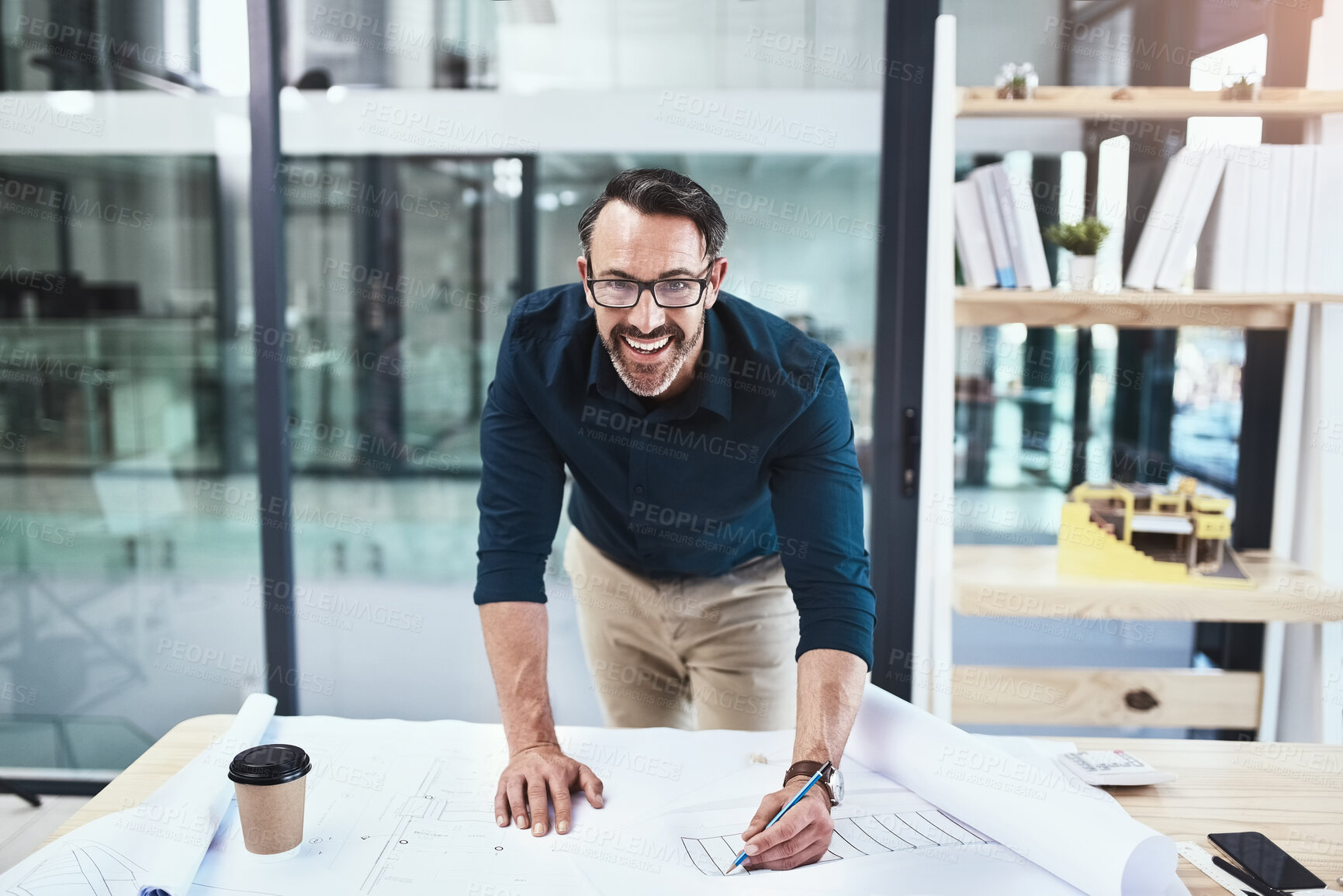 Buy stock photo Shot of a mature male architect working on a design in his office