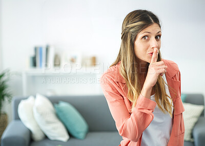 Buy stock photo cropped shot of a woman posing with her finger on her lips