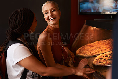 Buy stock photo Pizza, friends and women laughing with food at a restaurant with order and lunch with conversation. Customer, dinner and happy people together with bonding and smile at a diner with meal and takeaway