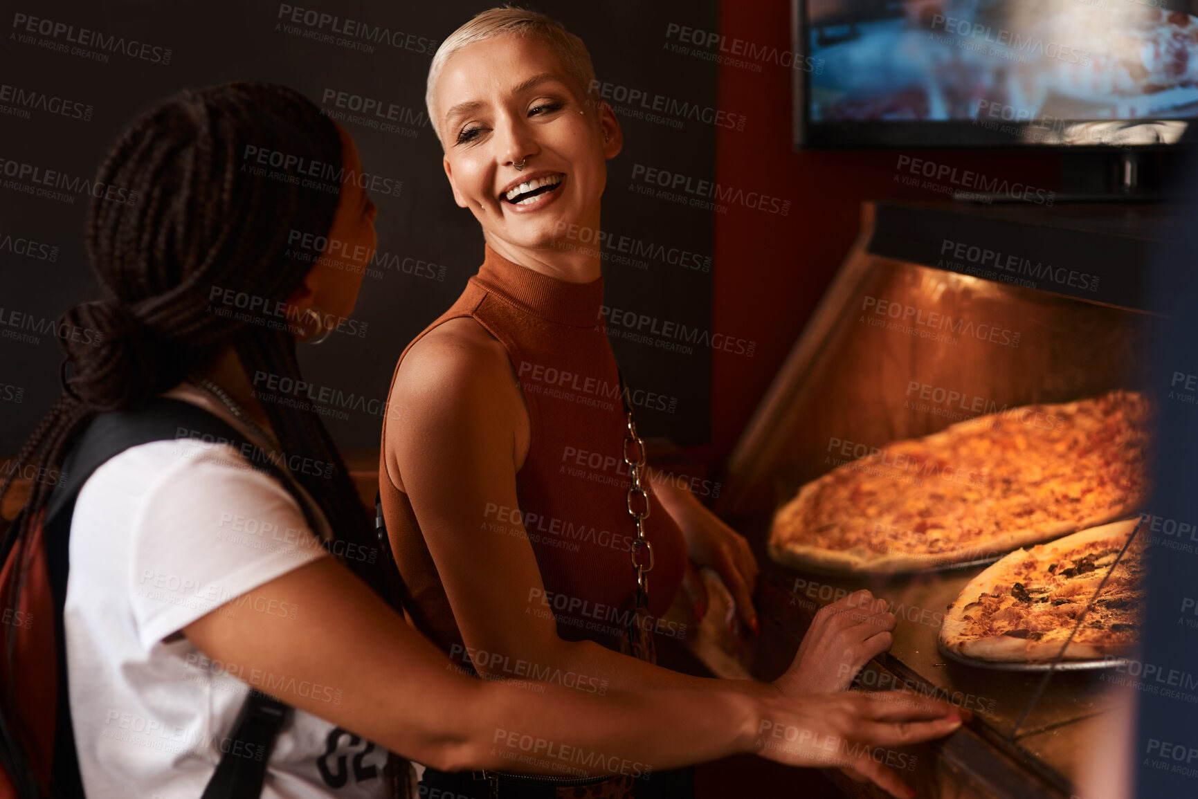 Buy stock photo Pizza, friends and women laughing with food at a restaurant with order and lunch with conversation. Customer, dinner and happy people together with bonding and smile at a diner with meal and takeaway