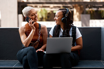 Buy stock photo Laptop, couple and women in city with phone for social networking, internet and contact. Dating, lgbtq relationship and people on computer in conversation, talking and bonding in town with smartphone