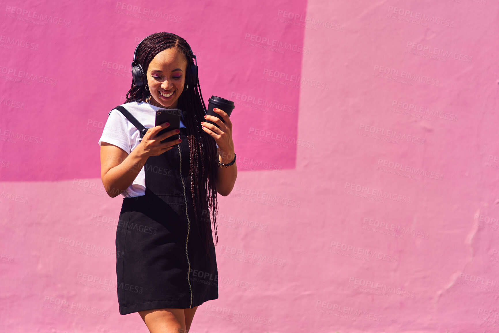 Buy stock photo Woman, phone and outdoor for music or coffee, streaming sound and subscription by pink background. Female person, latte and listening to podcast or online for social media, song and travel in city