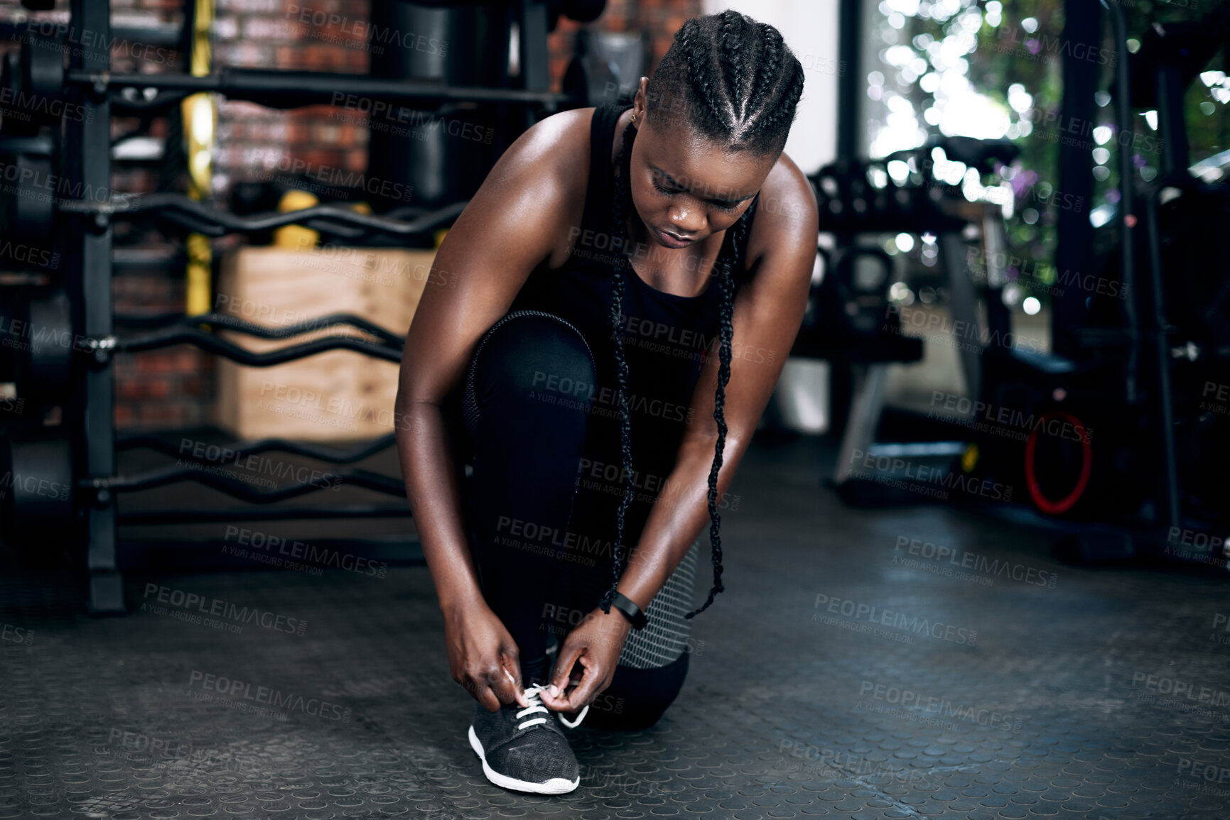 Buy stock photo Tie shoes, black woman and gym for exercise, fitness and health in wellness club. Shoe laces, footwear and sneakers for cardio workout and bottle for female person, trainer and foot for training