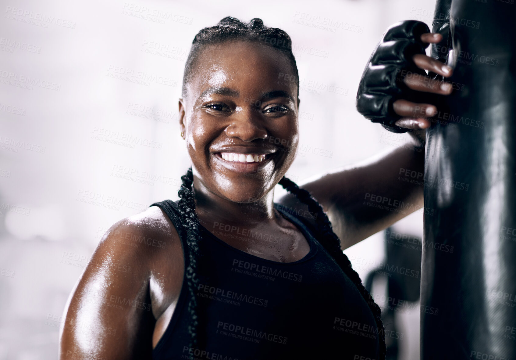 Buy stock photo Black woman, portrait and boxing bag for fitness, sweat and confidence for workout. Training, combat sports and cardio for body health and wellness, smile and gloves for African person in gym