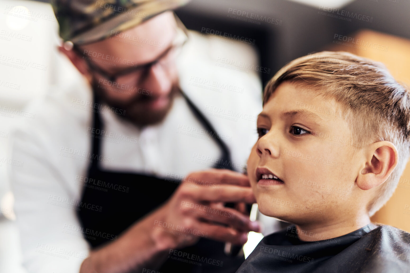 Buy stock photo Child client, trim and barber in barbershop with clippers for cutting, makeover or grooming service. Boutique, customer and hairstylist for haircut, hair care or hairdresser treatment in salon