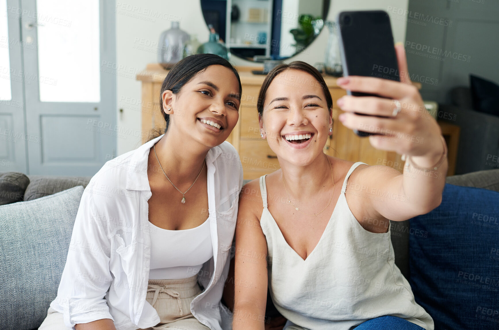 Buy stock photo Happy woman, friends and photography with selfie on sofa for memory, bonding or moment together at home. Female person or young people with smile for picture or capture on mobile smartphone at house