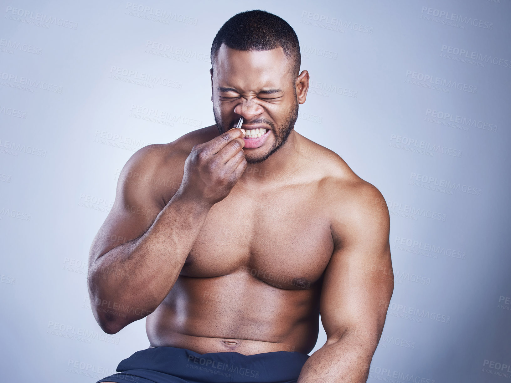 Buy stock photo Black man, tweezers and nose hair in studio, grooming and plucking for epilation on blue background. Male person, skincare and maintenance for hygiene routine or cleaning, beauty and facial cosmetics