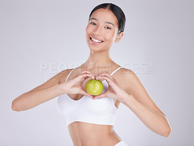 Buy stock photo Apple, smile and portrait of woman, studio and nutrition for health with food, underwear and wellness. White background, fruit and face of person, heart and happiness with hands, diet and snack