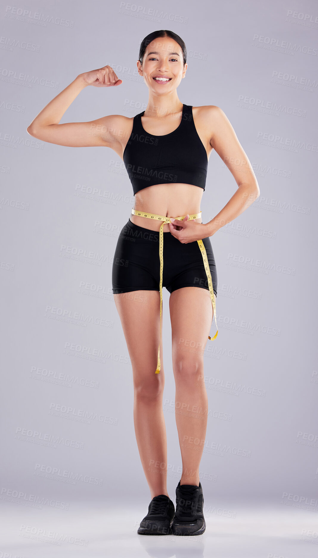 Buy stock photo Measure, progress and woman lose weight with exercise and flexing on studio background. Confident, athlete and portrait with pride after training with commitment to fitness and workout for health