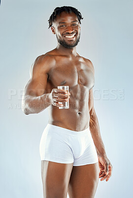 Buy stock photo Black man, water glass and portrait in studio for fitness, health and wellness or training. Liquid, hydration and bodybuilder in underwear with smile for exercise and workout by white background