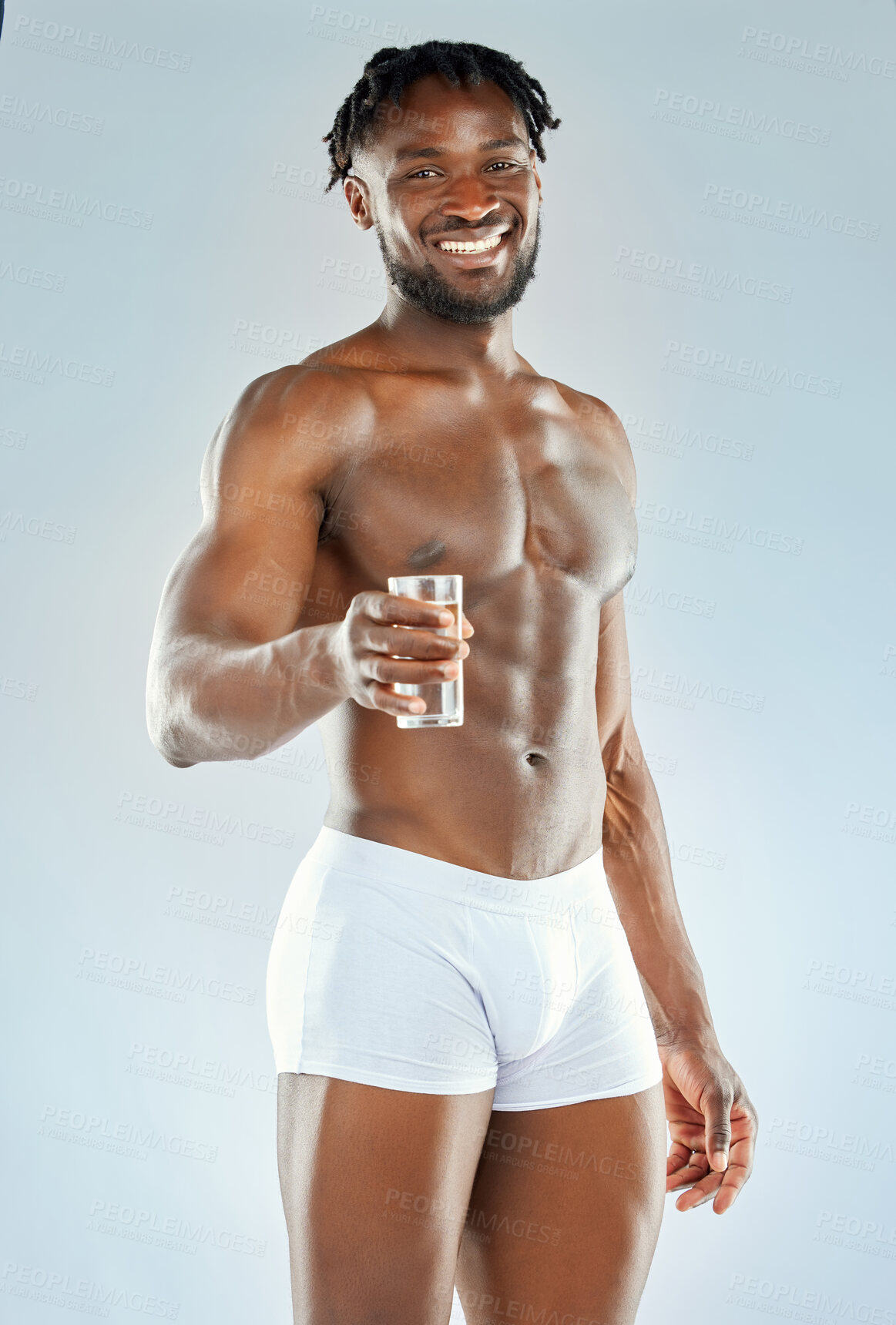 Buy stock photo Black man, water glass and portrait in studio for fitness, health and wellness or training. Liquid, hydration and bodybuilder in underwear with smile for exercise and workout by white background