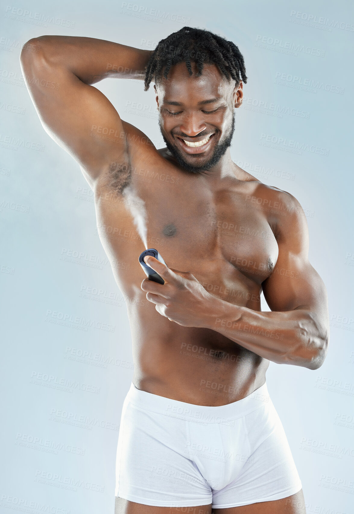 Buy stock photo Deodorant, spray and black man in studio for grooming, beauty and body hygiene on blue background. Skin, health and male applying aerosol, fragrance and scent product for underarm care treatment