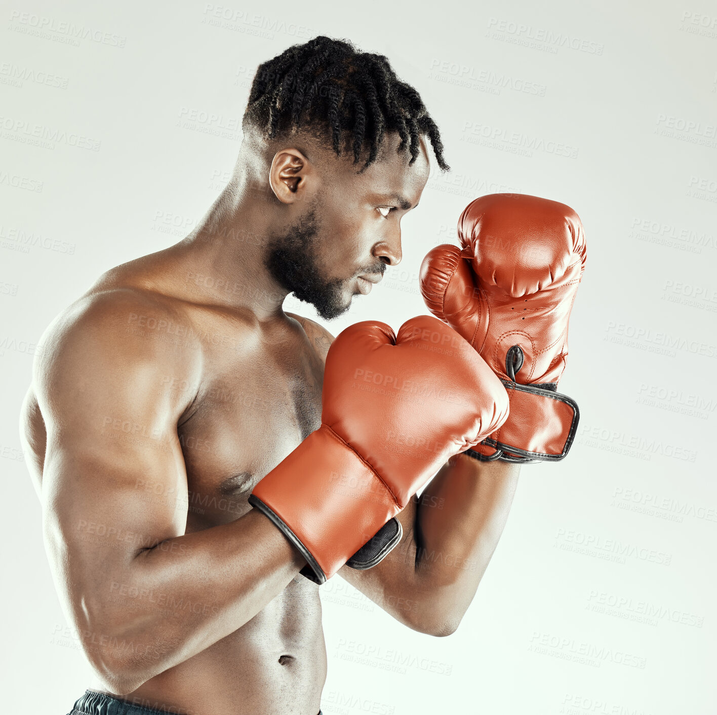 Buy stock photo Fitness, black man and boxing with gloves in studio for competition, strength challenge or self defence training on white background. Profile, power and athlete for muscle, champion or cardio workout