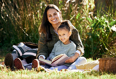 Buy stock photo Portrait, young girl and mother reading book outdoor in park for bonding, education and learning with love. Family, woman and daughter together in nature happy for support, development and knowledge