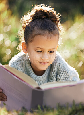 Buy stock photo Children, education and girl in a garden with book for reading, relax and child development in nature. Peace, fantasy or calm kid with fairytale, story and literacy for studying, learning or hobby