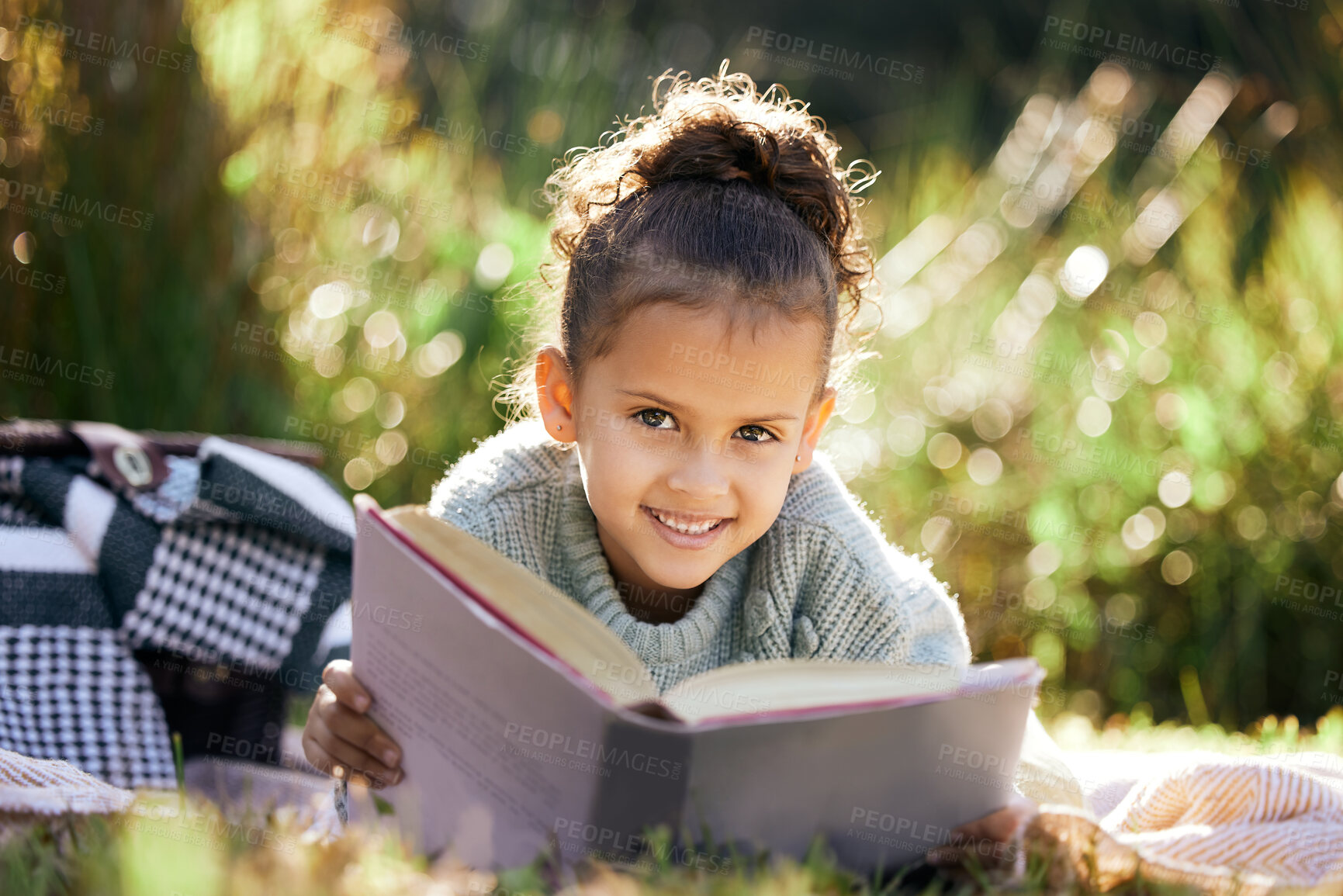 Buy stock photo Portrait, learning and girl in a garden with book for reading, picnic and child development in nature. Smile, fantasy or happy kid with fairytale, story and literacy for studying, education or hobby