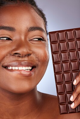 Buy stock photo Thinking, woman and happy in studio with chocolate for unhealthy diet, sugar or cheat day on gray background. Closeup, diabetes and black model for snack temptation, sweet addiction or cacao bar