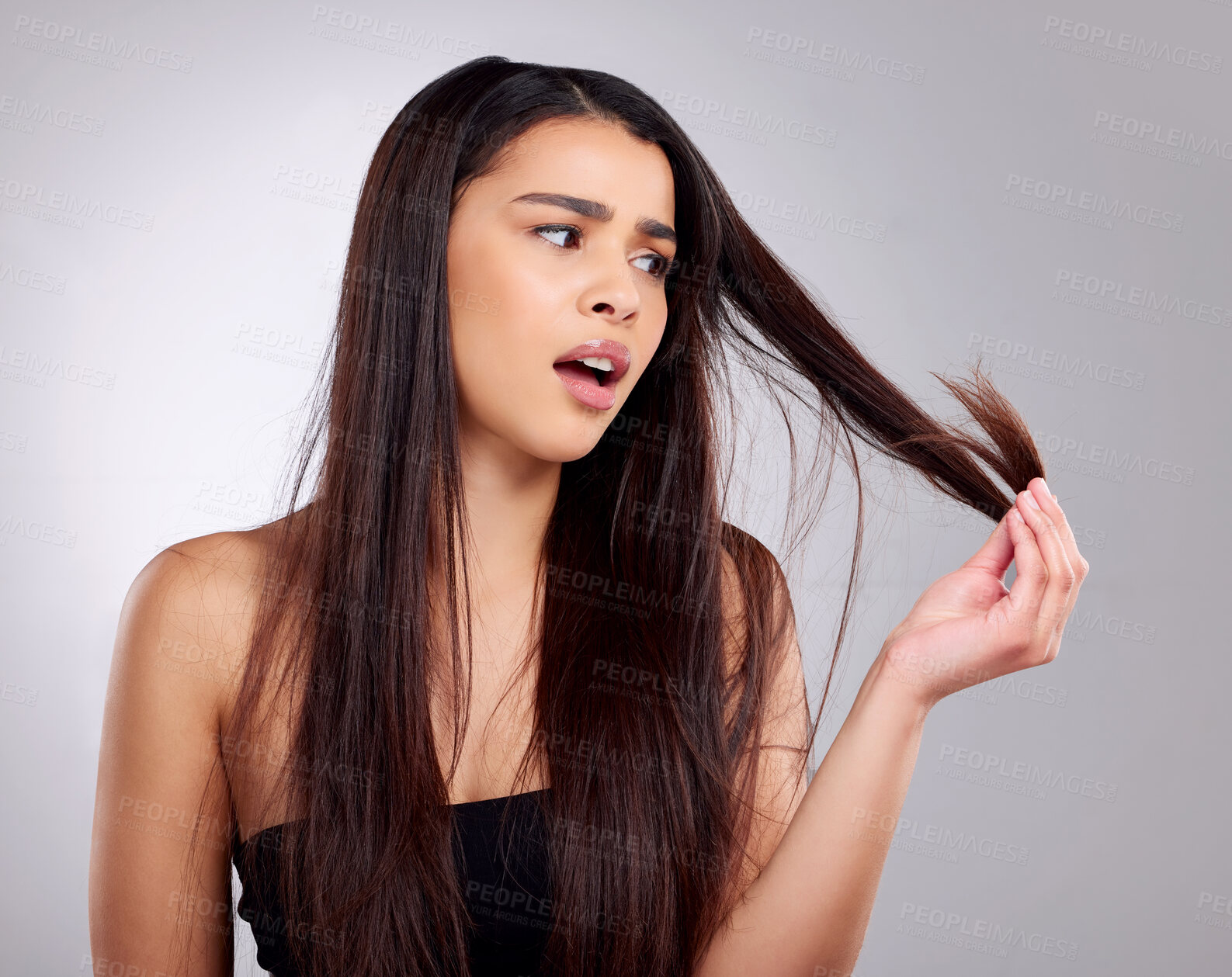 Buy stock photo Hair care, problem and woman in studio with worry for frizz, hairstyle or split ends with gray background. Damaged, beauty and hand of model for hairloss, salon stress or tangle strand on mockup