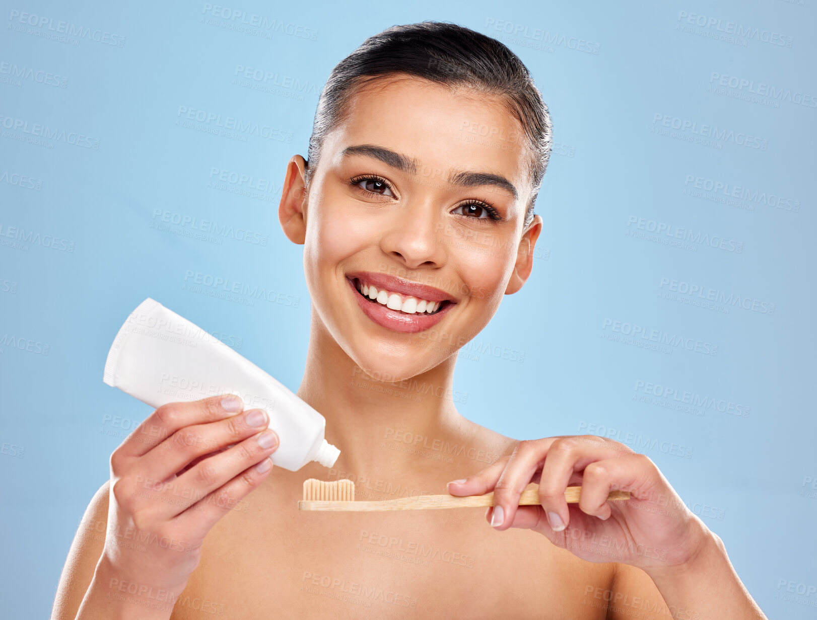 Buy stock photo Woman, studio and portrait with toothbrush or toothpaste, dental care and mouth wellness for hygiene. Bamboo, smile and eco friendly product on blue background, fresh breath and oral health or beauty