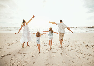 Buy stock photo Beach, airplane and family running in nature with freedom, vacation and love at ocean. Travel, energy and back of children with parents at sea for flying games, support and having fun while bonding