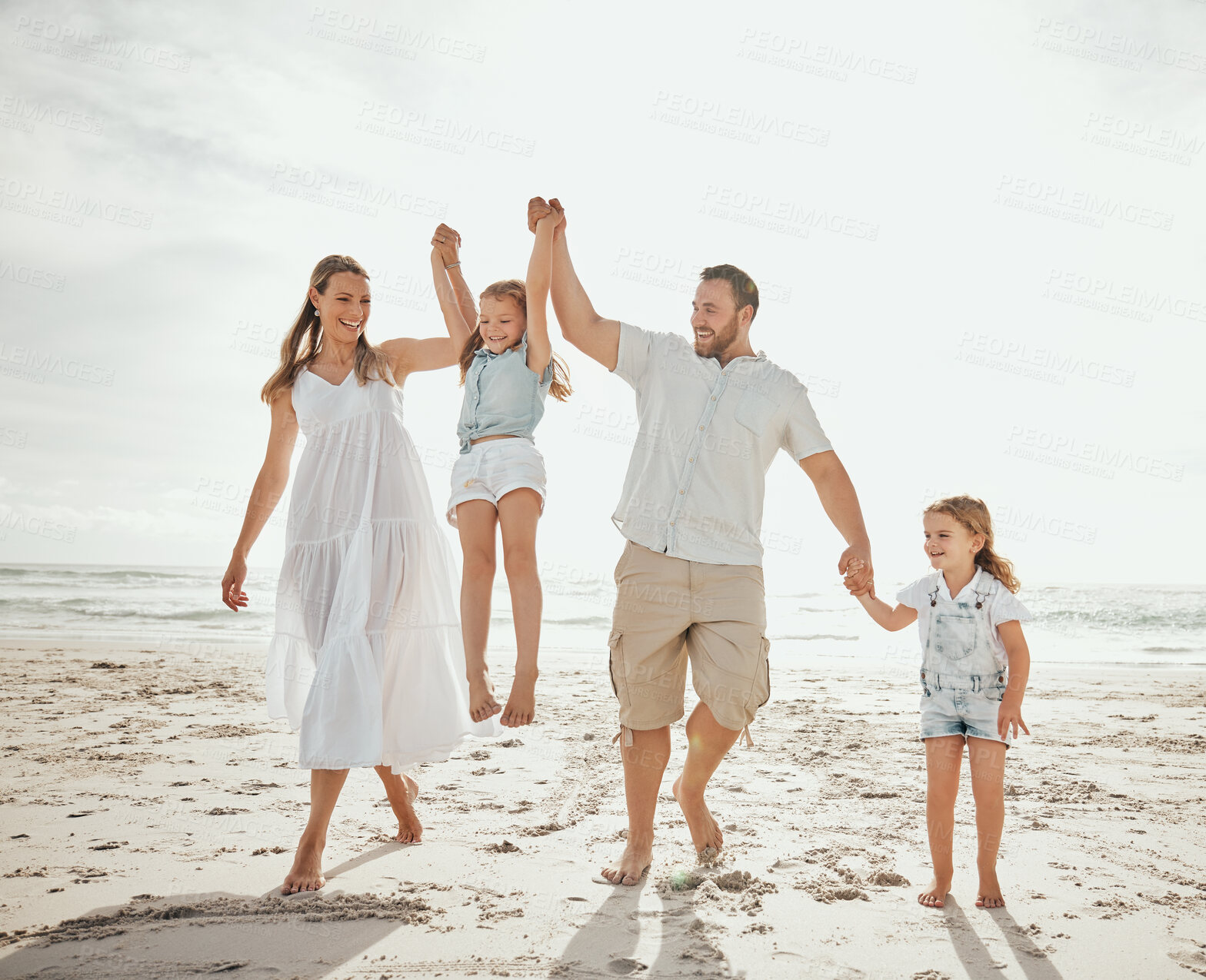 Buy stock photo Beach, swing and kids with parents holding hands at sunset for morning games, freedom and adventure in nature. Support, lifting and happy family at ocean for travel, journey or fun bonding in Cancun