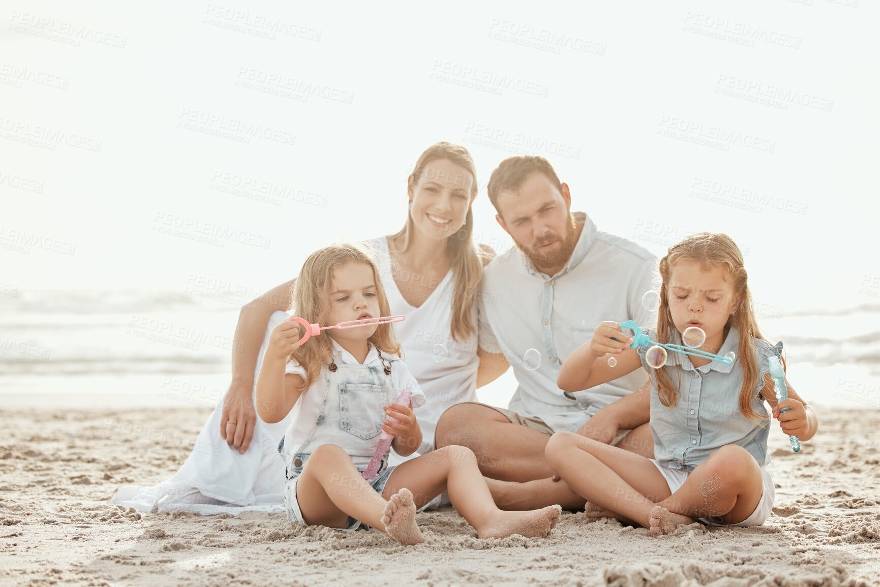 Buy stock photo Happy, bubbles and family in beach for vacation, smile and celebration of adoption of siblings in San Diego. Outdoor, playful and kids blow wand, joy and woman with pride for children with man